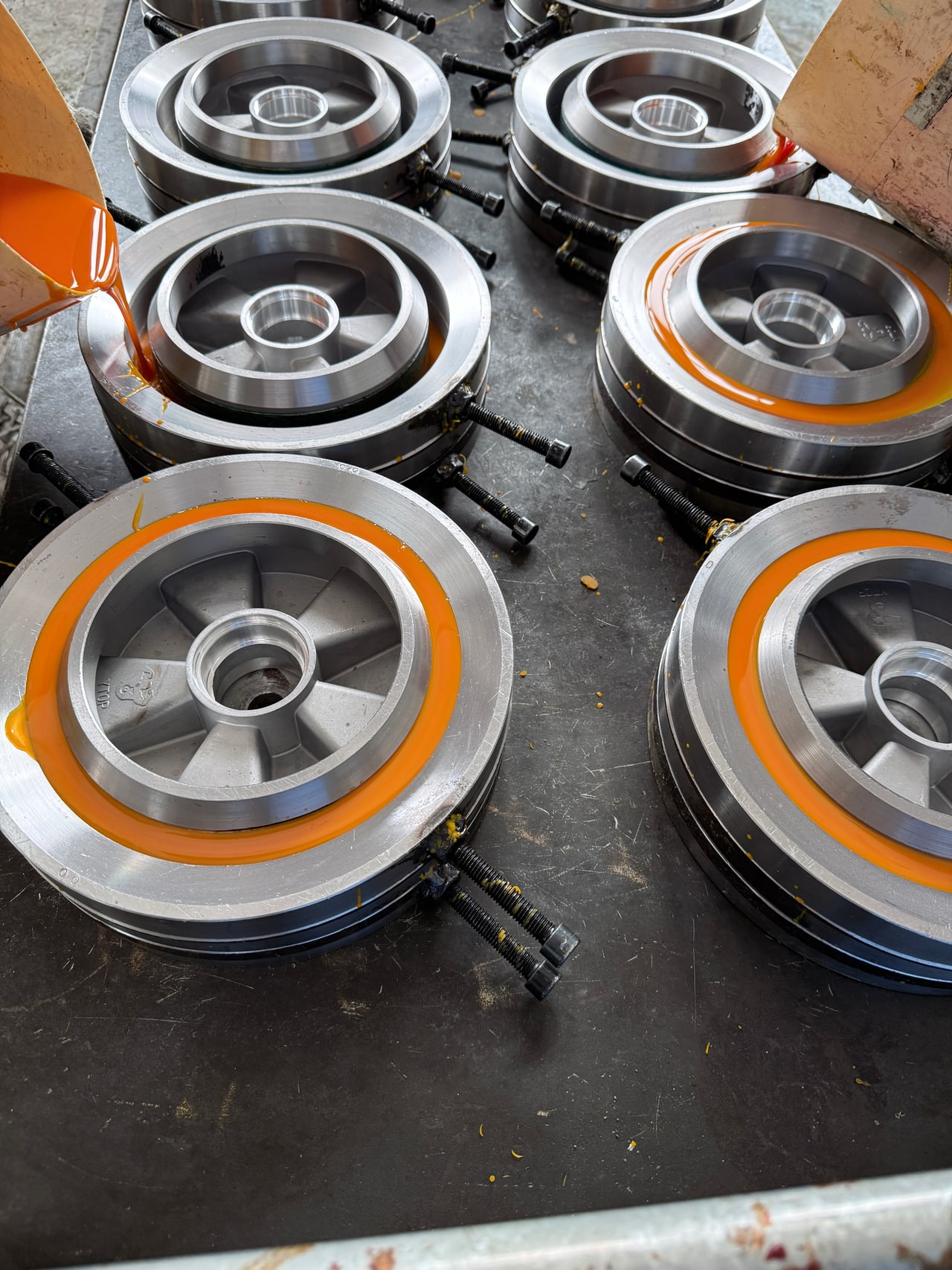 Polyurethane casting around metal wheel cores in molds
